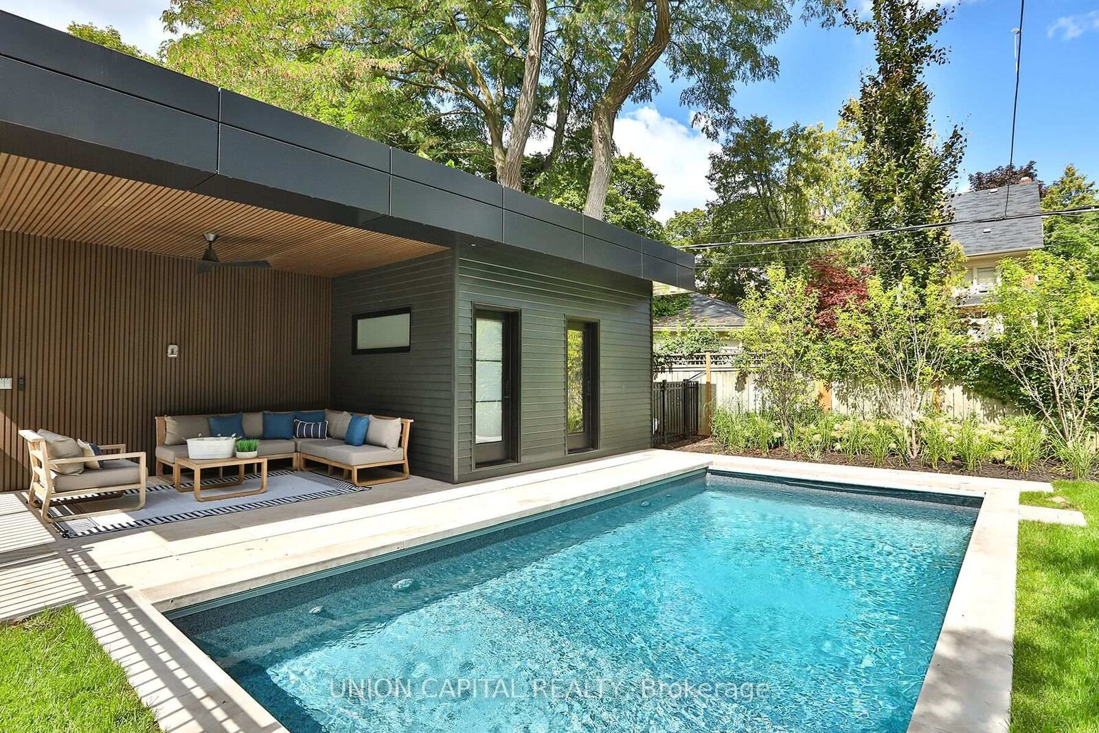 Backyard with heated saltwater pool and four-season pool house